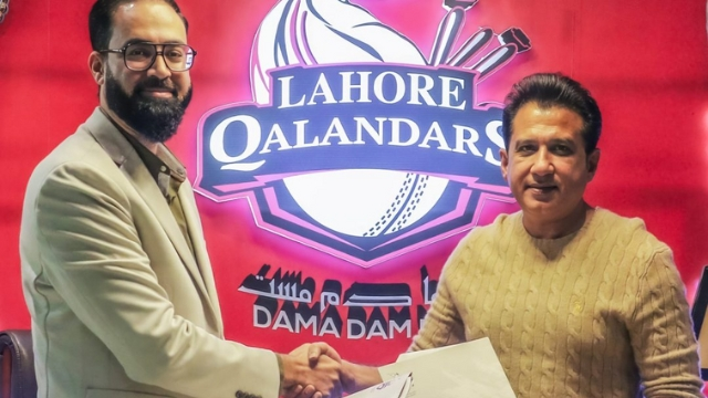 Atif Rana, CEO of Lahore Qalandars, shaking hands with a GripActive spokesperson in front of the team logo, marking a partnership announcement for PSL 2025.