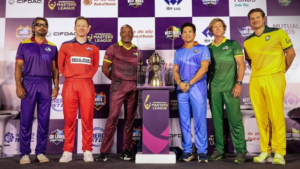 Legendary cricketers Brian Lara, Eoin Morgan, Kumar Sangakkara, Sachin Tendulkar, Jonty Rhodes, and Shane Watson pose in team kits around the trophy at the launch of the International Masters League 2025.