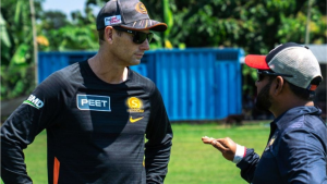 Adam Voges engaged in a discussion during a cricket training session, wearing Perth Scorchers team gear.