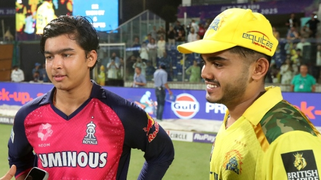 Ayush Mhatre and Vaibhav Sooryavanshi smiling and chatting on the cricket field after an IPL 2025 match, wearing Rajasthan Royals and Chennai Super Kings jerseys respectively.