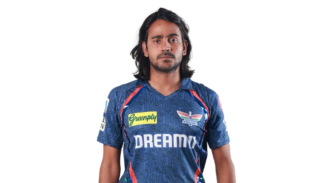 Portrait of Digvesh Singh wearing the Lucknow Super Giants jersey for the IPL, standing against a white background.