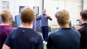 Graeme Swann speaking to a group of young cricketers during a coaching session for the Young Cricketers (YC) programme.