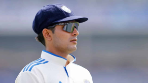 Shubman Gill, newly appointed India Test cricket captain, wearing sunglasses and a white Test jersey with blue accents.