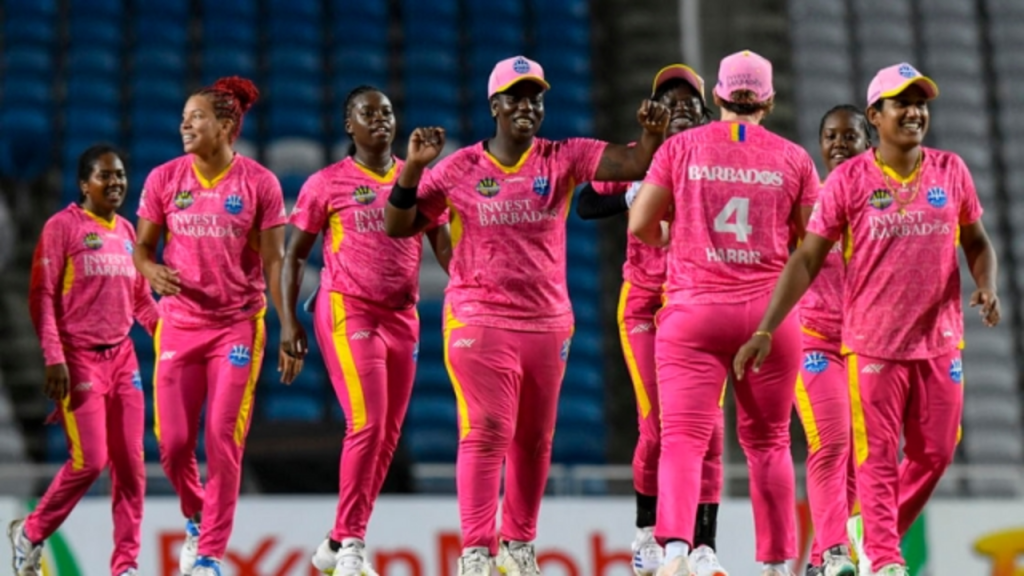 Barbados Royals women's team celebrating on the field during a Women's Caribbean Premier League (WCPL) 2025 match, wearing vibrant pink kits.