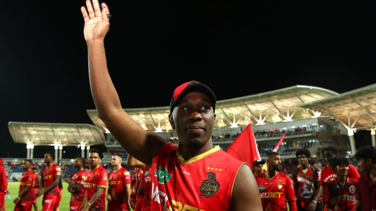 Dwayne Bravo celebrating with a wave after a match in the PSL 2025, wearing his team’s red jersey.