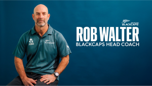 Rob Walter, head coach of the New Zealand Blackcaps, seated against a blue background wearing team apparel.