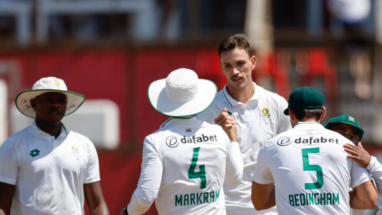 South Africa cricket team players in white Test jerseys celebrating a wicket during a match, with visible names Markram and Bedingham.