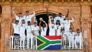 South Africa Test team celebrating their ICC World Test Championship 2025 victory on the Lord's balcony, holding the ICC mace with the national flag displayed.
