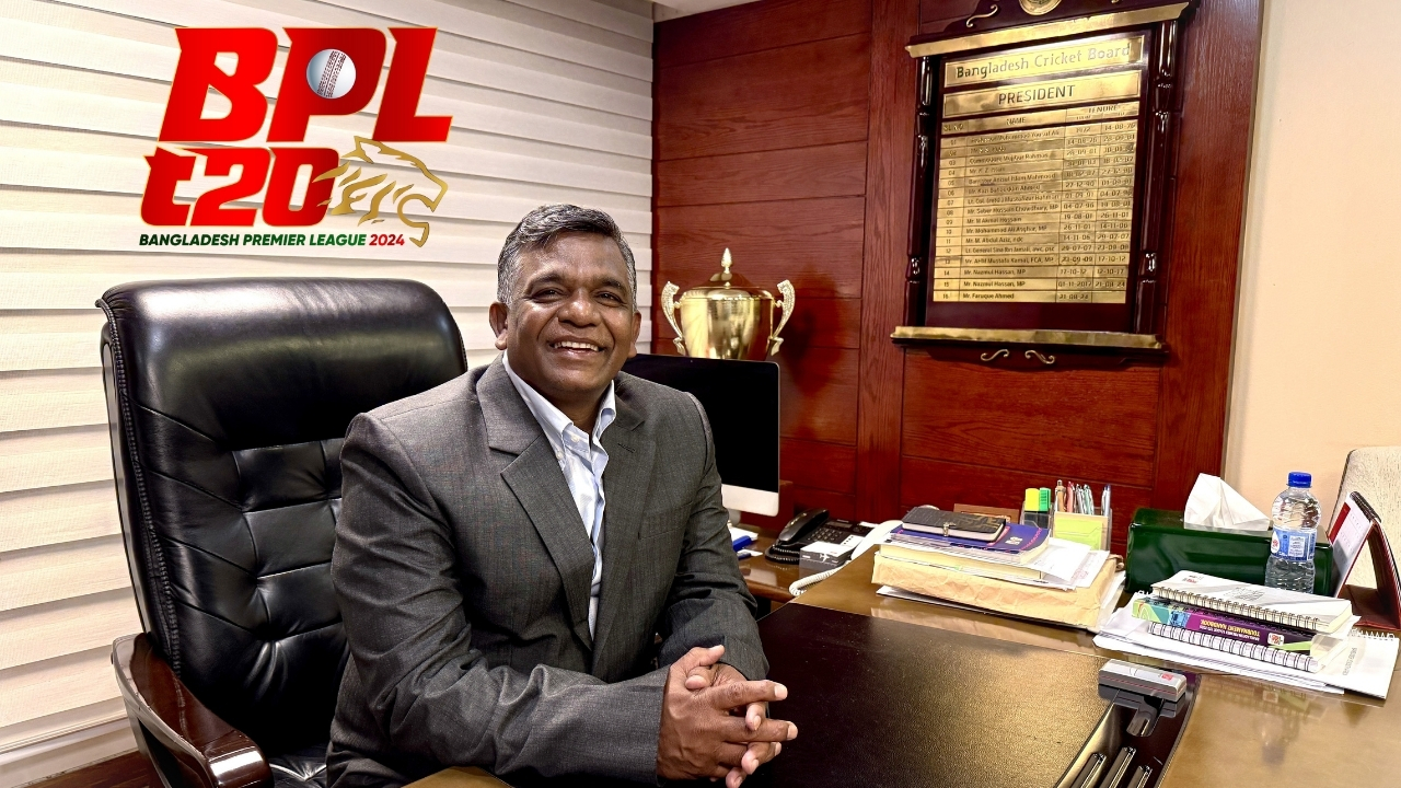 Amin Ul Islam seated at his office desk with the Bangladesh Premier League (BPL) 2024 logo in the background.