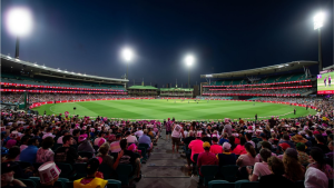 Packed crowd watching a Big Bash League night match at Sydney Cricket Ground under floodlights.