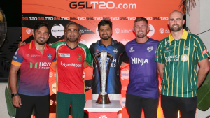 Captains of various teams in the Guyana Global Super League pose together with the tournament trophy in front of a branded backdrop.