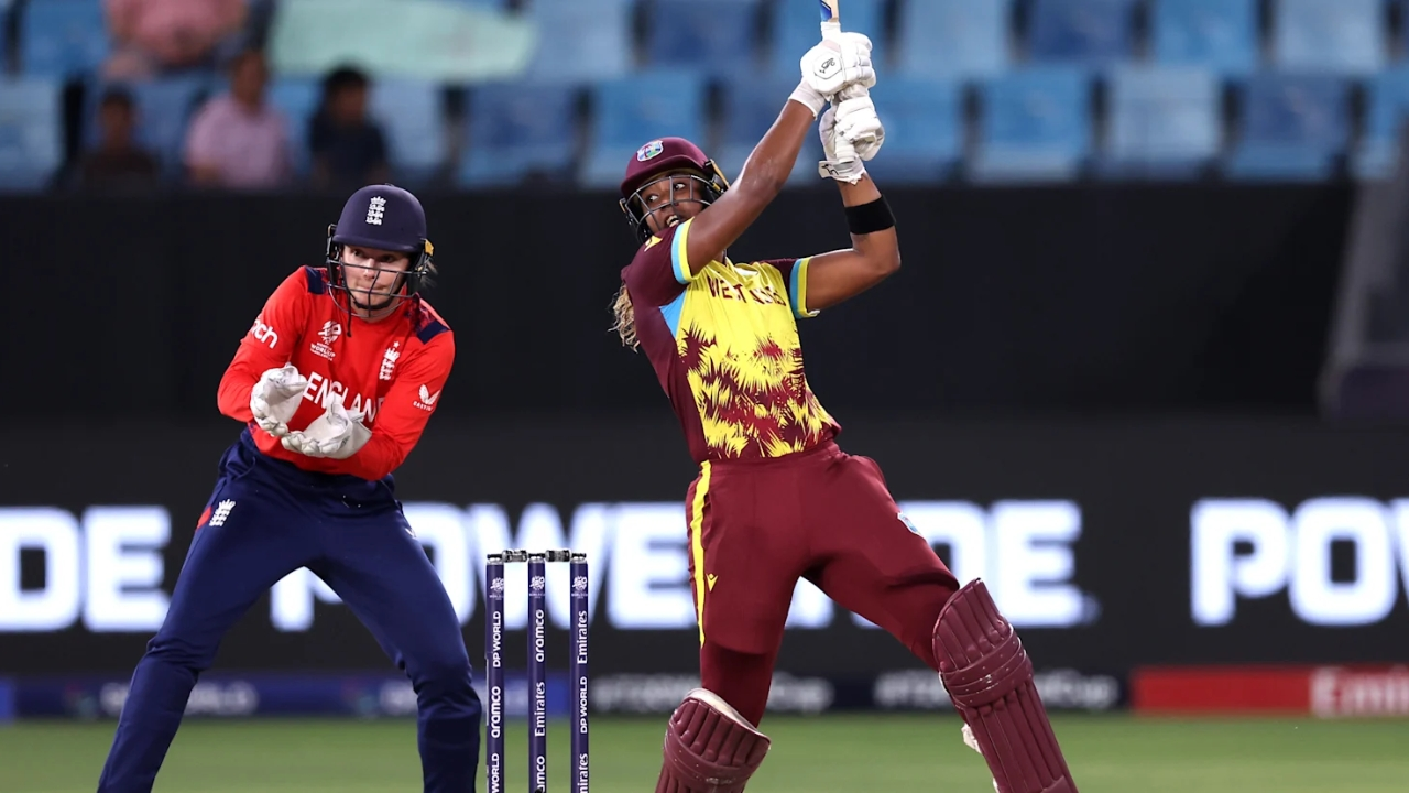 Hayley Matthews of West Indies plays a powerful shot during a women's T20 match against England, with the wicketkeeper in position behind the stumps.