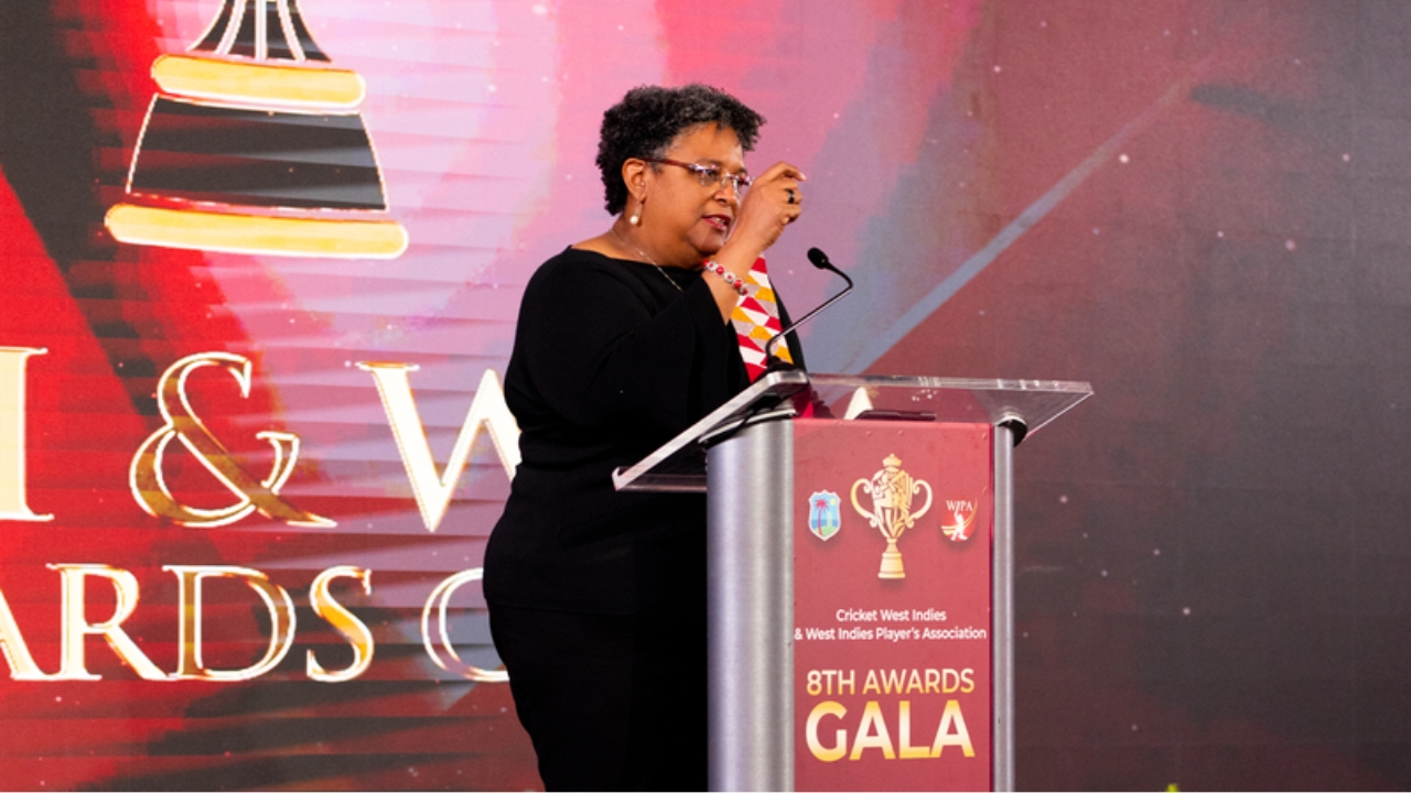 Barbados Prime Minister Mia Mottley delivering a speech at the podium during the Cricket West Indies and WIPA 8th Awards Gala, with event branding in the background.
