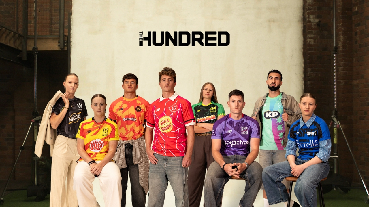 Male and female cricketers posing in The Hundred team jerseys under The Hundred logo in a studio setting.