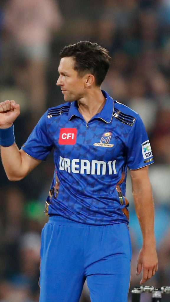 Trent Boult wearing the Mumbai Indians SA20 jersey during a cricket match, captured in action on the field.