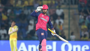Vaibhav Sooryavanshi celebrating after scoring runs during an IPL 2025 match, wearing Rajasthan Royals jersey and holding a cricket bat.