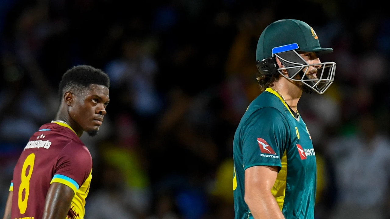 West Indies bowler Alzari Joseph stares at Australian batter Tim David during a T20 cricket match.
