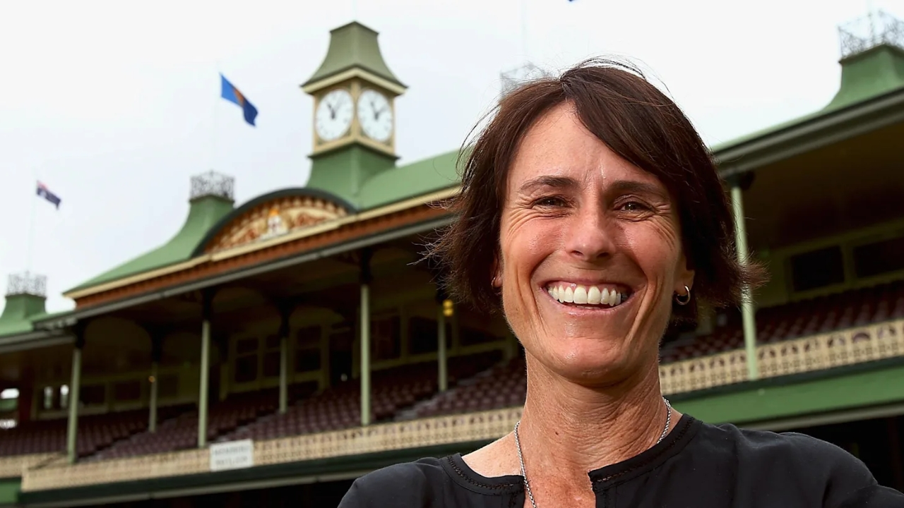 Belinda Clark smiling in front of the historic Members Pavilion at the Sydney Cricket Ground.