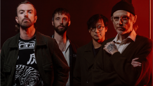 Australian rock band Birds of Tokyo posing for a promotional portrait with red lighting