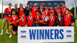 Canterbury cricket team celebrating with the Ford Trophy after winning the tournament, posing with medals and the trophy.