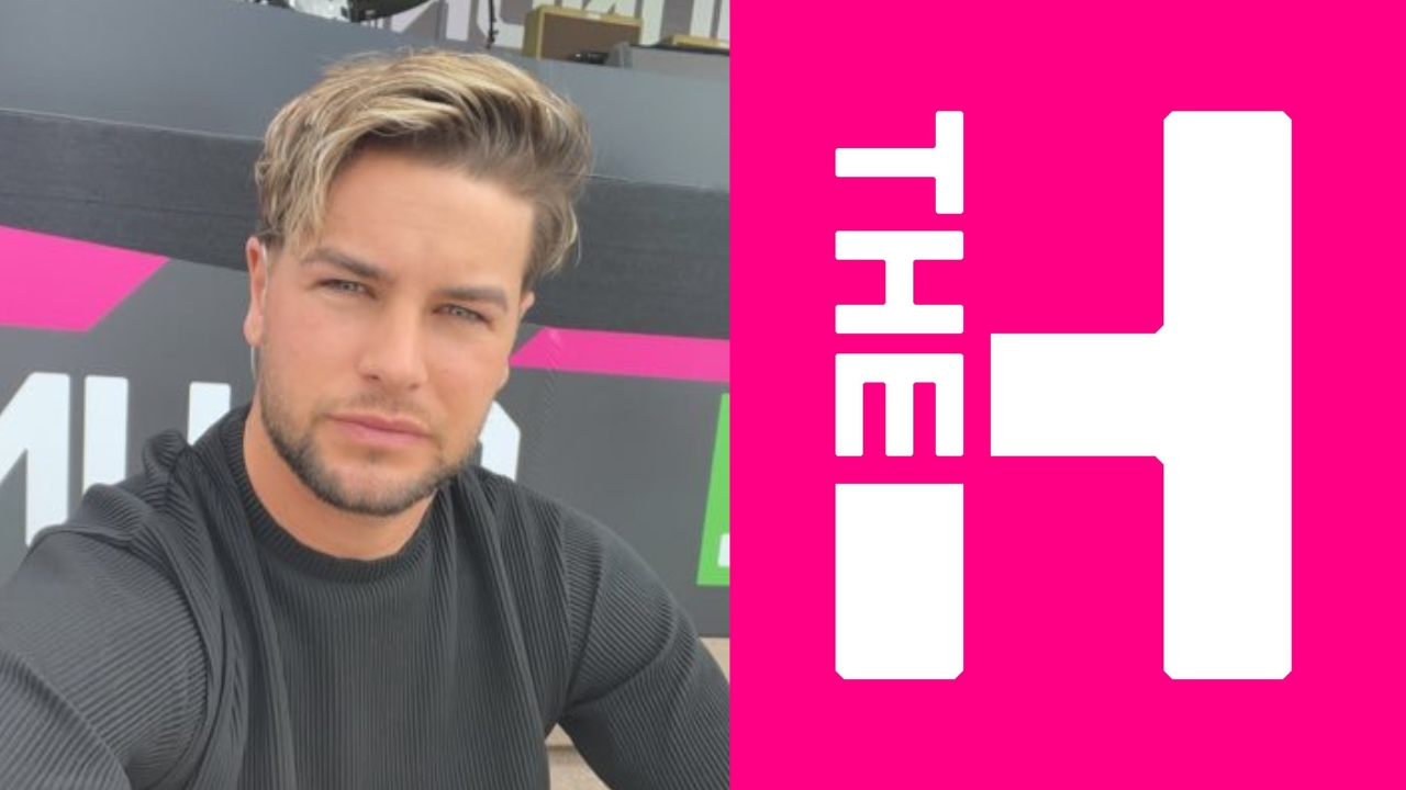 Chris Hughes posing in front of a venue with The Hundred cricket tournament logo displayed on a bright pink background.