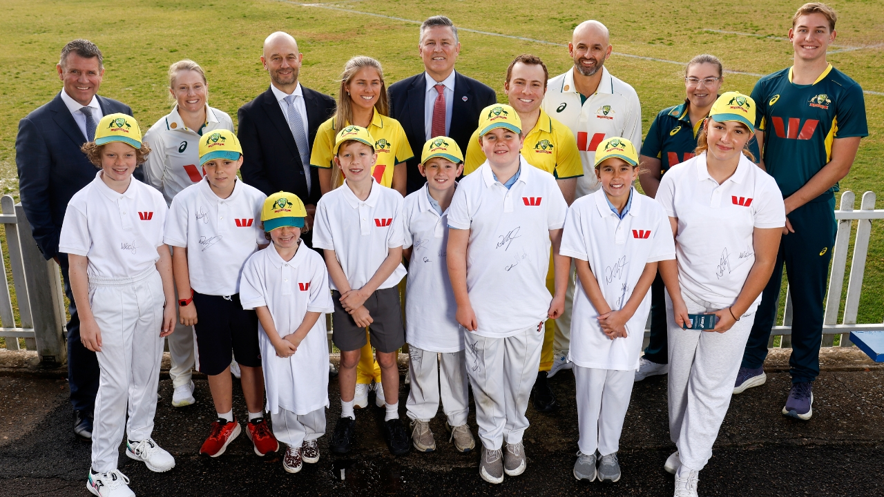 Nathan Lyon, Alyssa Healy, Todd Greenberg, and Mike Baird posing with young cricketers during a Cricket Australia and Westpac partnership event in 2025.