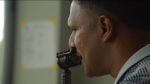 Close-up of Darren Ganga speaking into a microphone during cricket commentary.