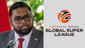 President Irfaan Ali speaking at an event with ExxonMobil Guyana Global Super League T20 logo beside him