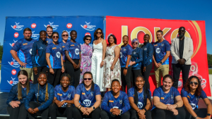 Namibia women’s cricket team, the Capricorn Eagles, posing with sponsors and officials during a team photo event in 2025 under clear blue skies.
