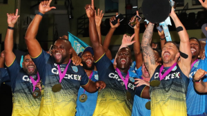 Saint Lucia Kings players celebrating with trophy and medals after winning the Caribbean Premier League, wearing team jerseys and cheering on stage.