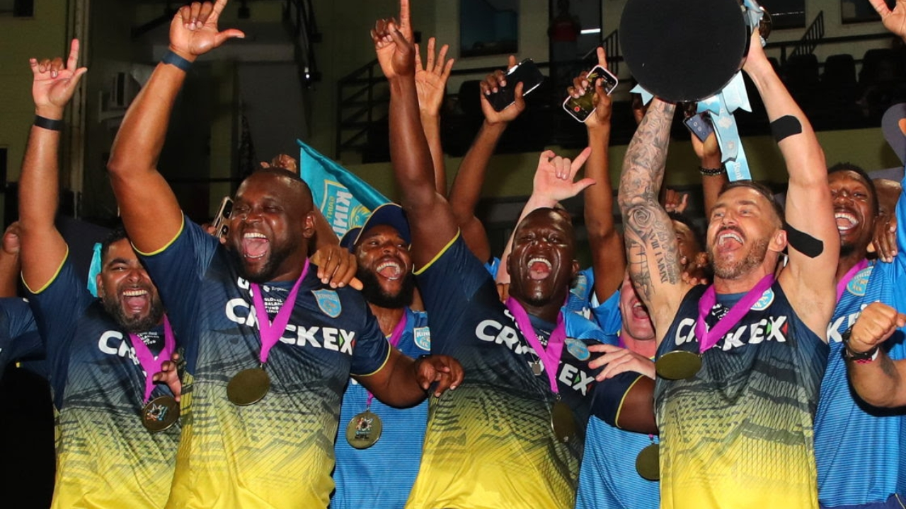 Saint Lucia Kings players celebrating with trophy and medals after winning the Caribbean Premier League, wearing team jerseys and cheering on stage.