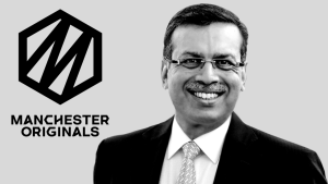 Sanjiv Goenka smiling in a suit next to the Manchester Originals cricket team logo on a grey background.