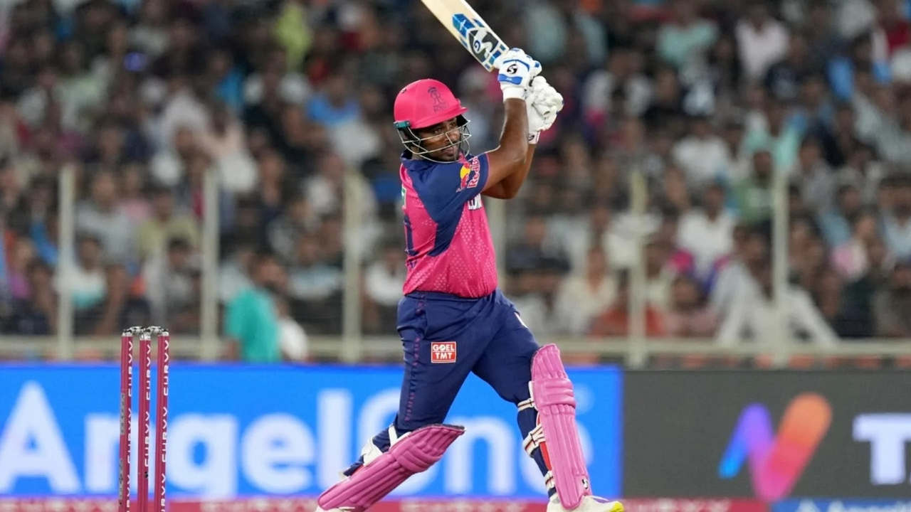 Sanju Samson playing a shot in Rajasthan Royals jersey during an IPL cricket match.
