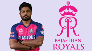 Sanju Samson in Rajasthan Royals jersey standing with arms crossed beside Rajasthan Royals logo in IPL 2025.