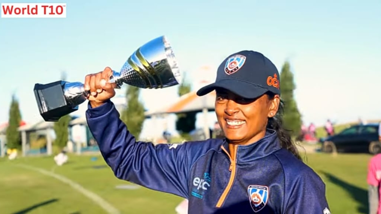 Smiling female cricketer holding trophy in celebration after winning World T10 tournament