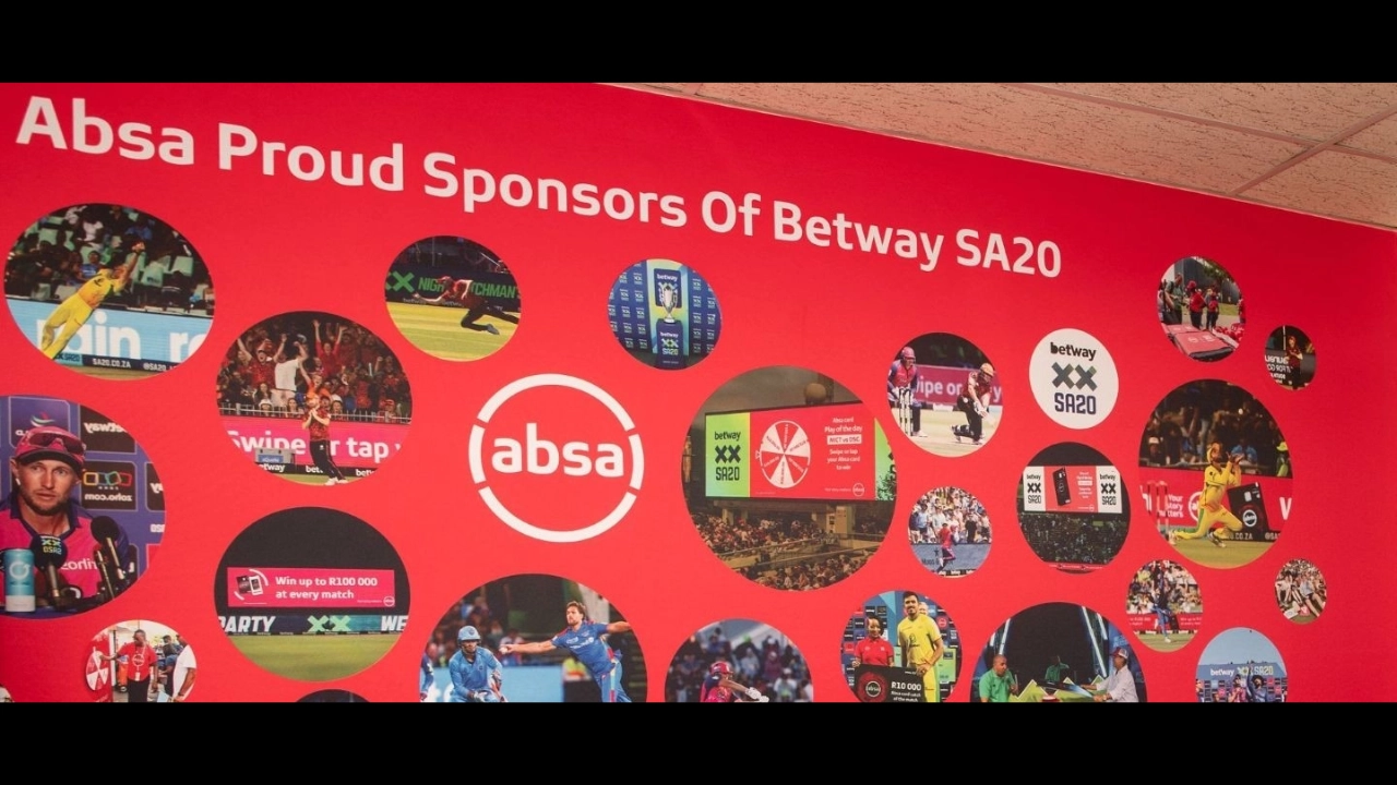 Absa branding on red wall showcasing sponsorship of Betway SA20 cricket league with action images and promotional visuals