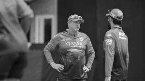 RCB head coach Andy Flower in discussion during a training session, black and white image