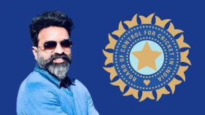 Arun Dhumal posing in front of the BCCI logo on a blue background, representing the Board of Control for Cricket in India.