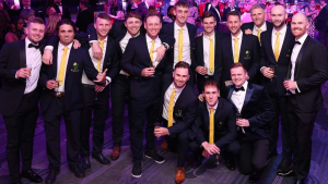 Group photo of cricket players dressed in formal attire during a gala awards night event in 2025