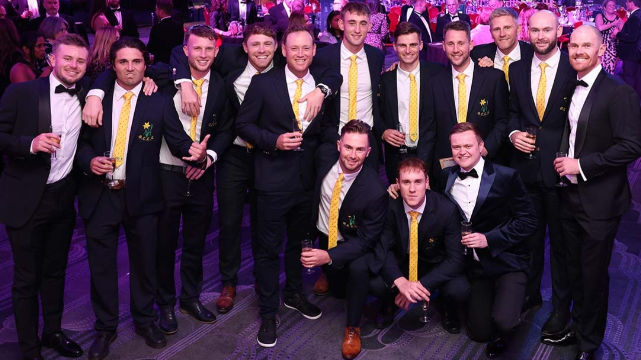 Group photo of cricket players dressed in formal attire during a gala awards night event in 2025