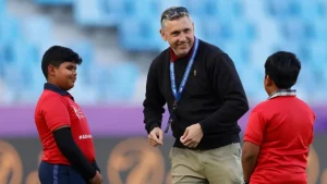 David White, CEO of DP World ILT20, interacting with two children on the field