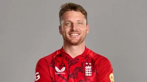 Jos Buttler wearing the England cricket team’s red jersey, posing for an official photo ahead of a 2025 match or tournament.
