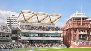 View of a packed grandstand at Lord's Cricket Ground with iconic red brick pavilion and modern canopy architecture