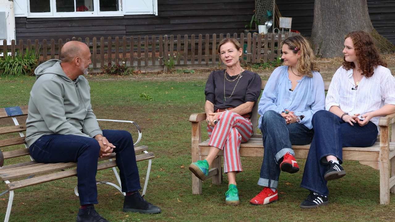 Mark Butcher interviews Graham Thorpe's family outdoors, sitting on benches in a garden setting.