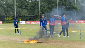 Namibian cricket players inspecting a burning patch on the pitch during a training session in Canada, 2025