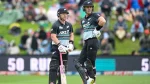 Two New Zealand cricketers in ANZ-branded black and teal uniforms standing at the crease during a T20I match