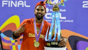 Nicholas Pooran celebrates with the 2025 Caribbean Premier League (CPL) championship trophy, wearing a champion's medal and red jersey.