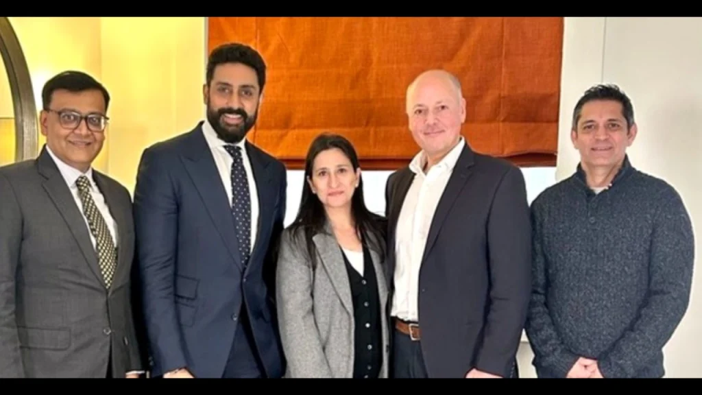 Priyanka Kaul, Abhishek Bachchan, Warren Deutrom, Saurav Banerjee, and Dhiraj Malhotra posing together during a business meeting.