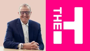 Richard Thompson seated in suit alongside The Hundred cricket league logo on a split background
