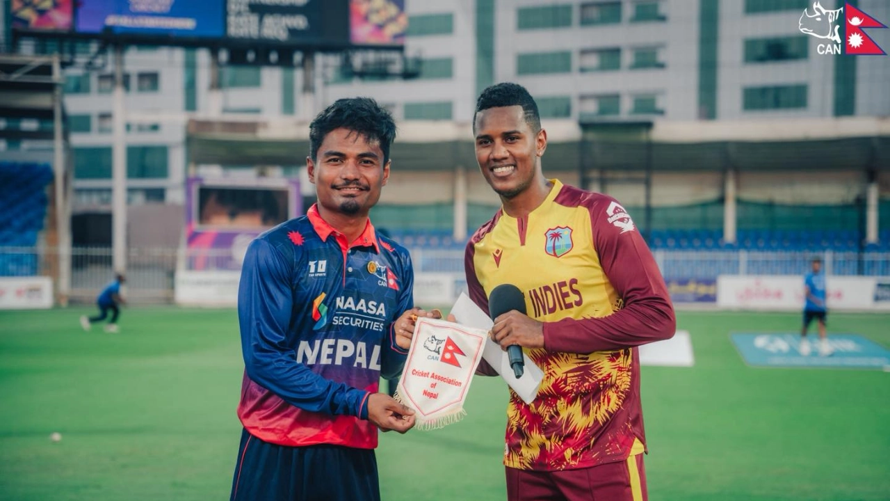 Rohit Paudel of Nepal and Akeal Hosein of West Indies at the toss holding a Cricket Association of Nepal pennant before their international match.